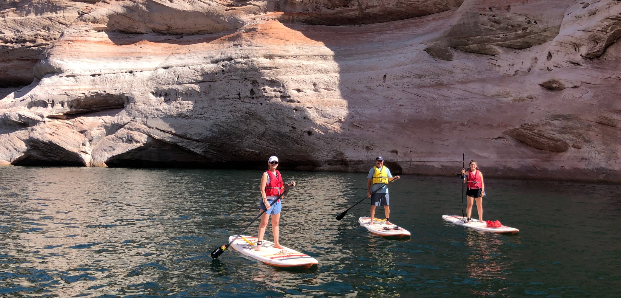 group of 3 people stand up paddleboarding antelope canyon