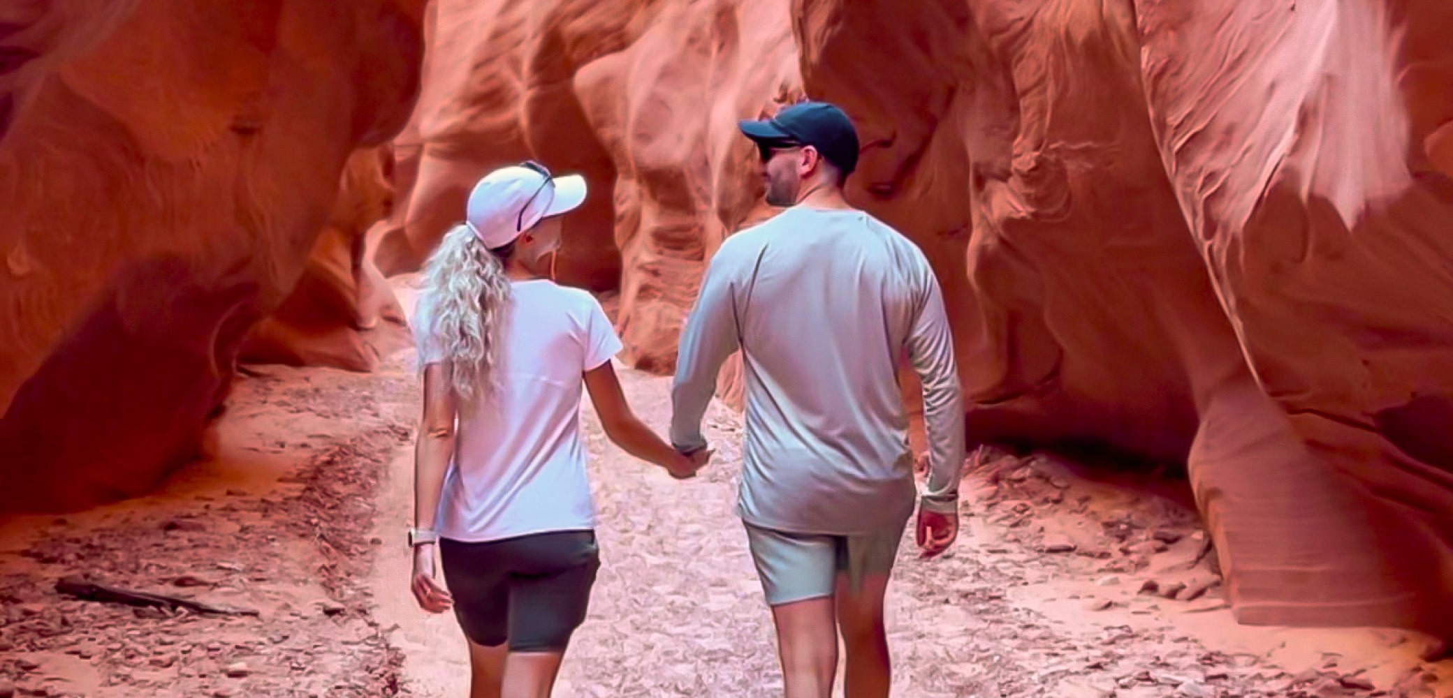 couple walking through antelope canyon