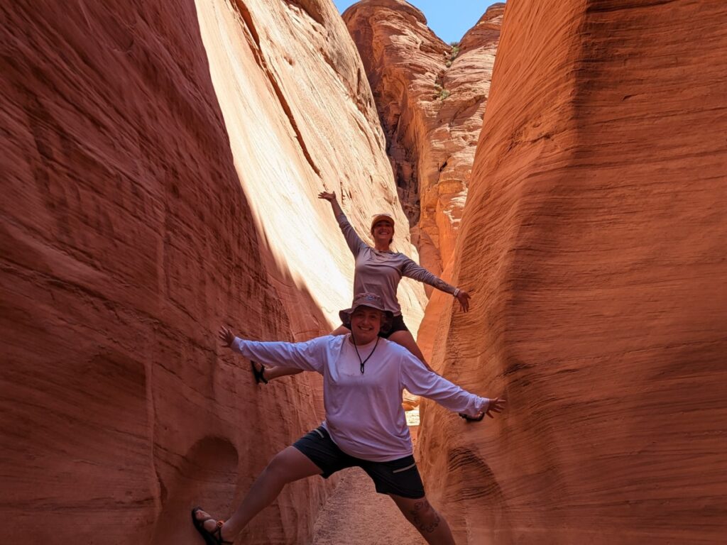 two people hiking in antelope canyon on a guided tour of lake powell and antelope canyon
