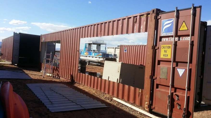A shipping container with a large rectangle cut out of it. 