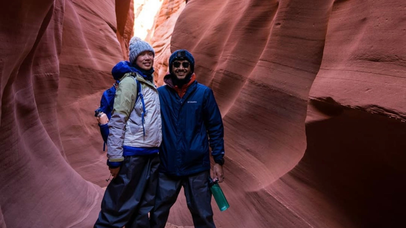 Two people pose in warm clothes during a lake Powell hike