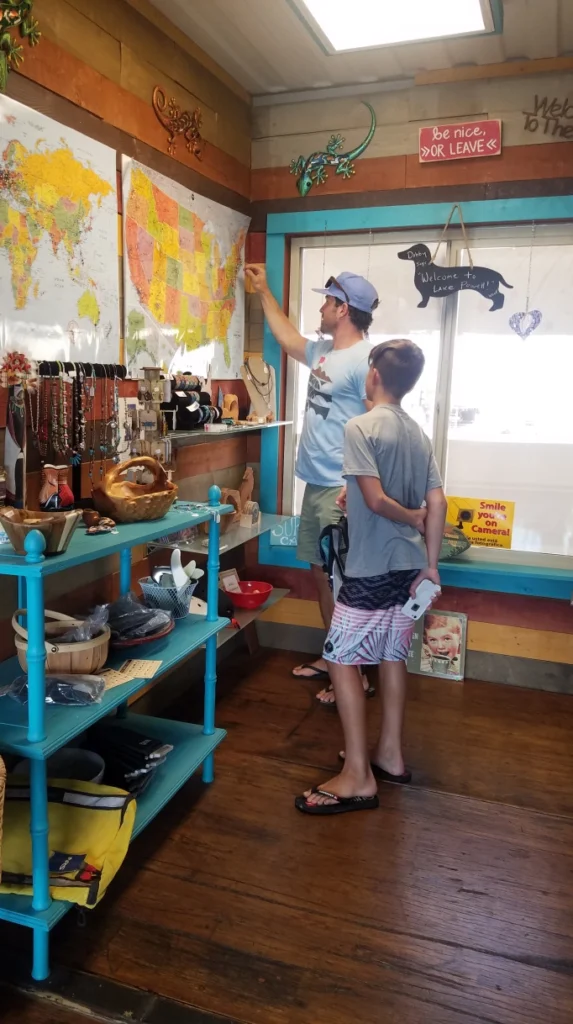 A father and son inspect a map in a shop